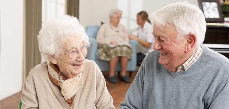 elderly couple smiling at each other in recreation room