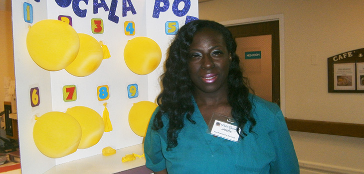 staff member in front of sign