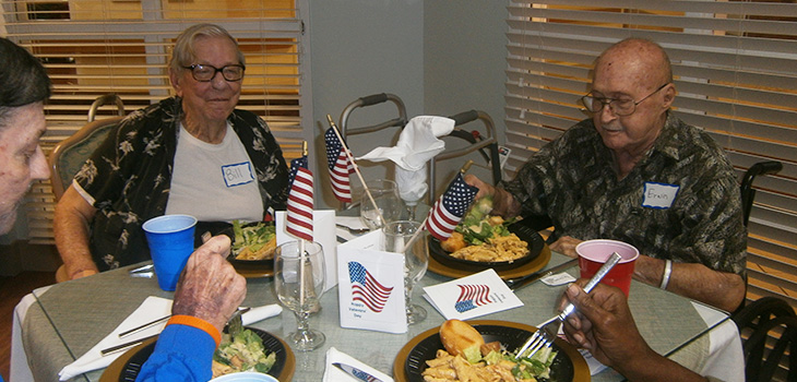 residents at table with flags