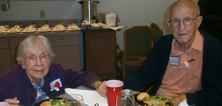 couple holding hands at table