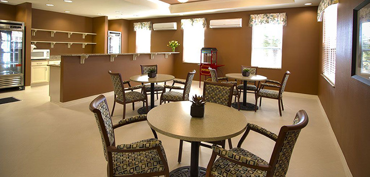 recreation area with tables, popcorn machine, drink refrigerator and microwave