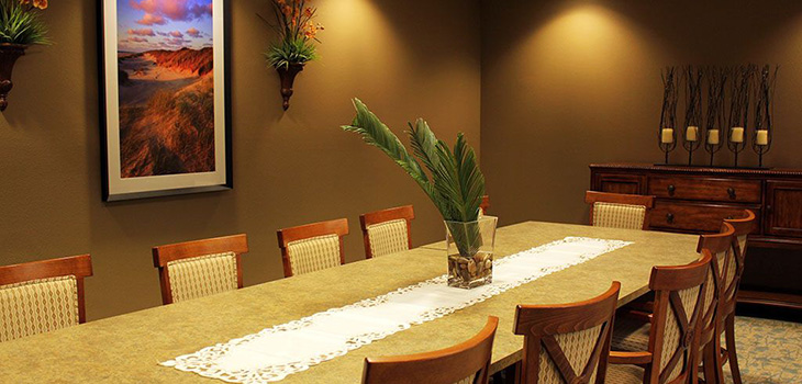 private dining area with artwork on walls and plants for accents